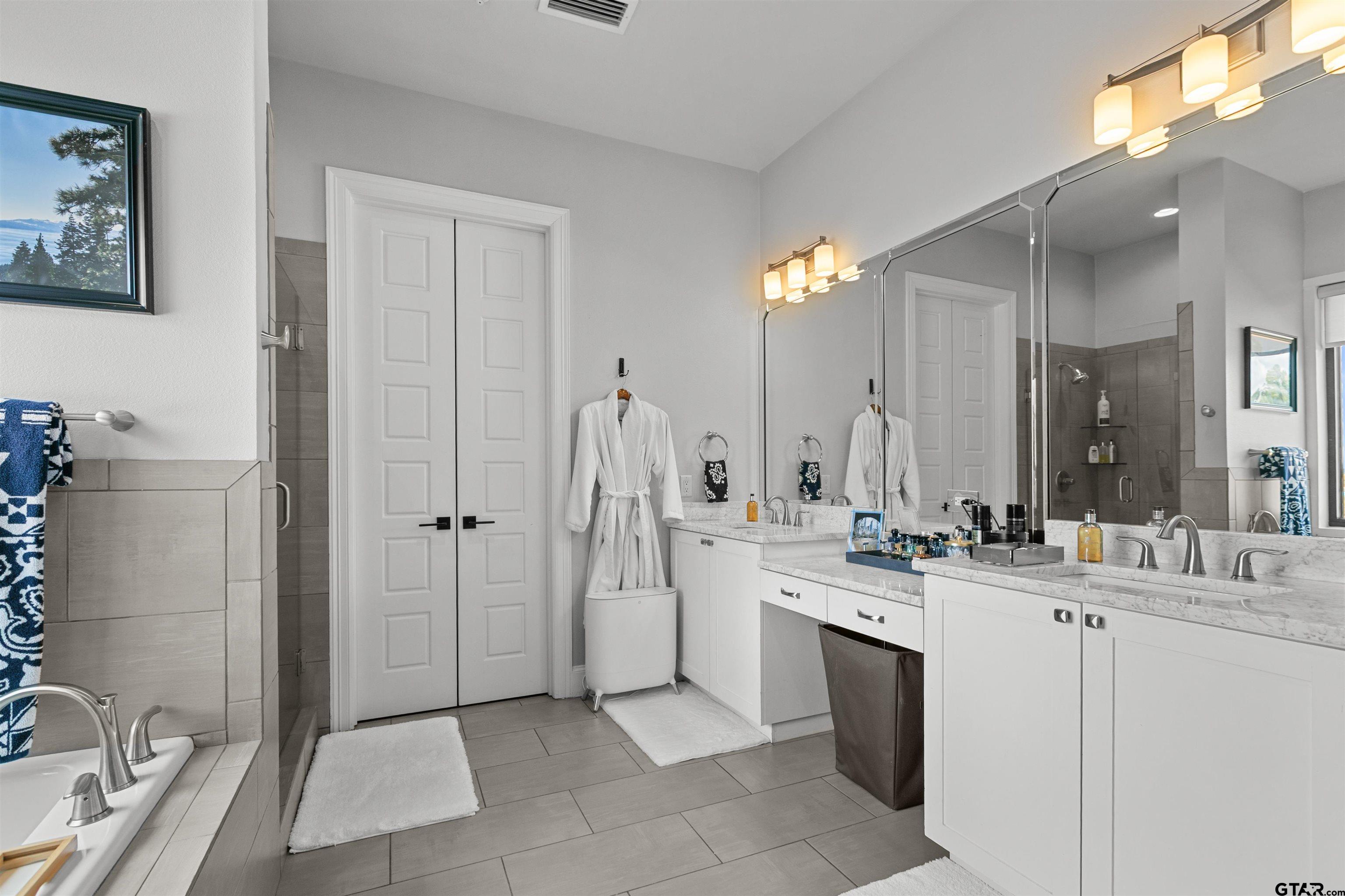 2981 Crest Ridge Drive, Unit 7 Tyler, TX 75703 - Photo 16 of 22 a bathroom with a double vanity sink and a mirror