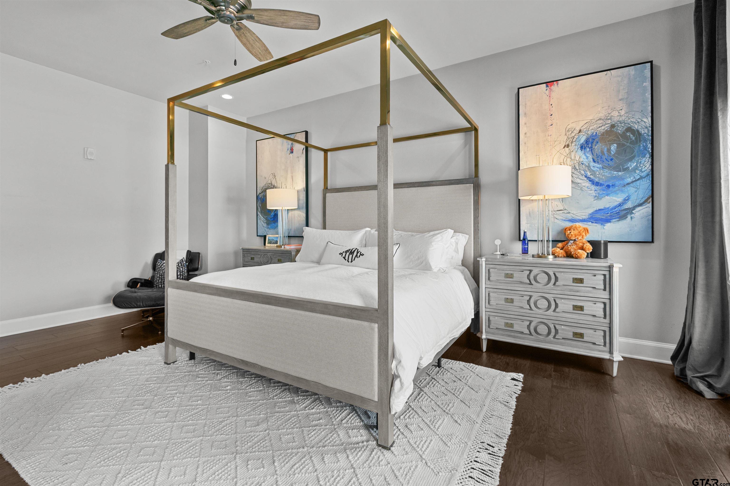 2981 Crest Ridge Drive, Unit 7 Tyler, TX 75703 - Photo 19 of 22 a bedroom with a bed and a painting on the wall