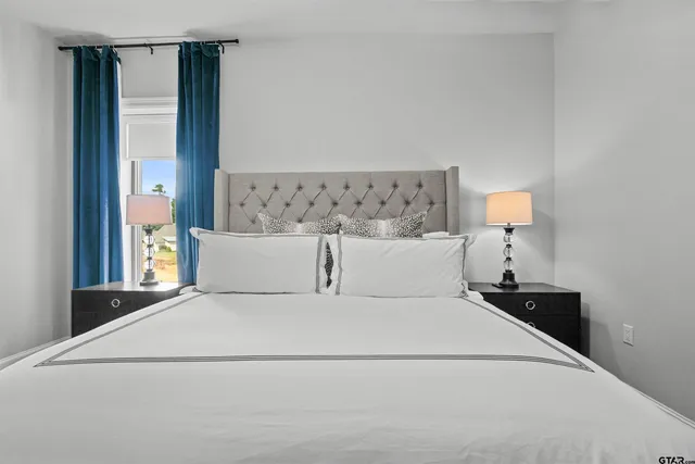a large white bed in a white room
