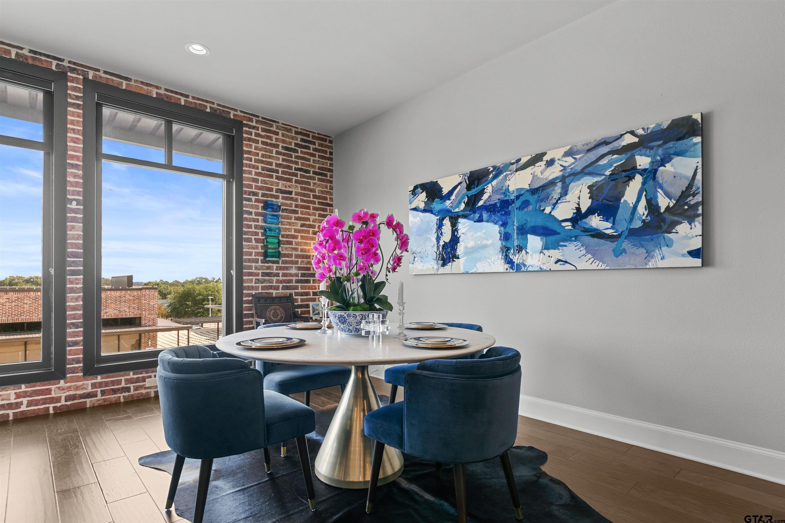 2981 Crest Ridge Drive, Unit 7 Tyler, TX 75703 - Photo 6 of 22 a view of a dining room with furniture window and wooden floor