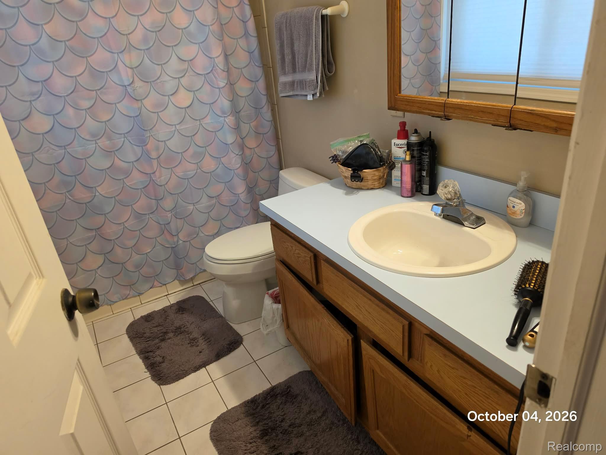 34781 Union Lake Road Clinton Township, MI 48035 - Photo 20 of 38 Built-in vanity with wood-finish cabinetry, integrated sink, and light-colored countertop