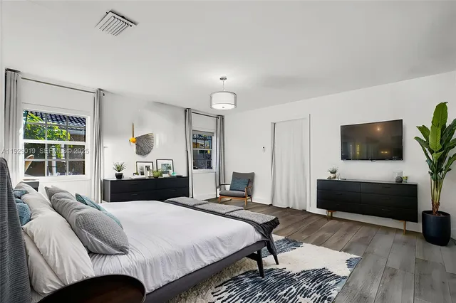 a bathroom with a double vanity sink mirror and toilet