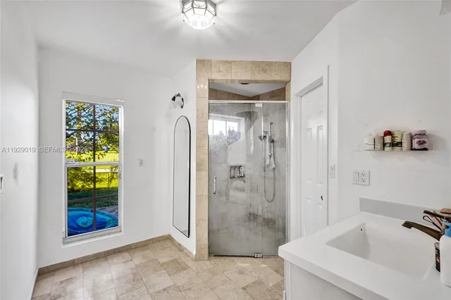 a bathroom with a toilet sink a shower and mirror