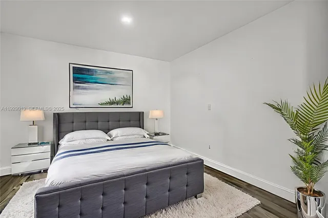 a bedroom with bed and a chandelier