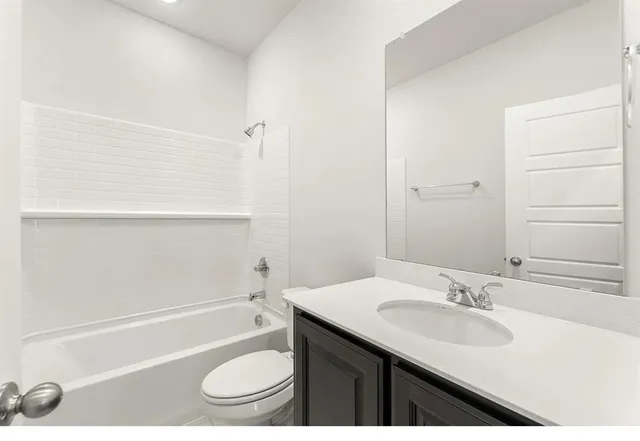 a bathroom with a sink a toilet and a bathtub