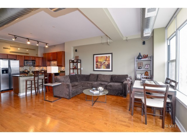 901 West Madison Street, Unit 809 Chicago, IL 60607 - Photo 4 of 12 a living room with furniture a rug kitchen view and a large window