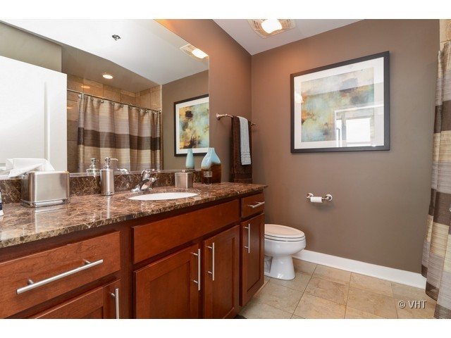901 West Madison Street, Unit 809 Chicago, IL 60607 - Photo 7 of 12 a bathroom with a toilet sink and mirror