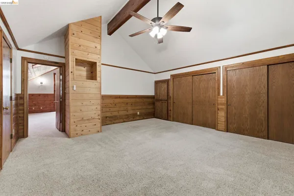 a view of an empty room with a ceiling fan