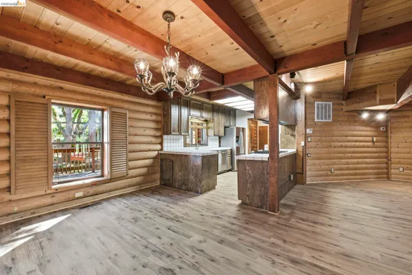 a view of a room with wooden floor