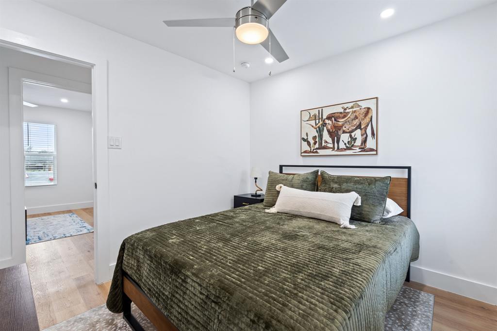 2706 Wheless Lane, Unit 401 Austin, TX 78723 - Photo 19 of 24 Hardwood floors and a sleek ceiling fan define this comfortable bedroom retreat.