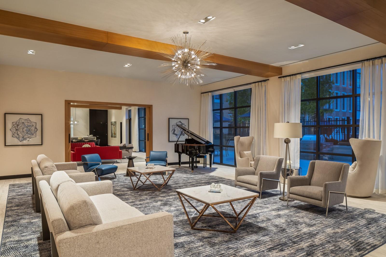 100 Garvies Point Road, Unit 1211 Glen Cove, NY 11542 - Photo 18 of 24 Living room with a notable chandelier