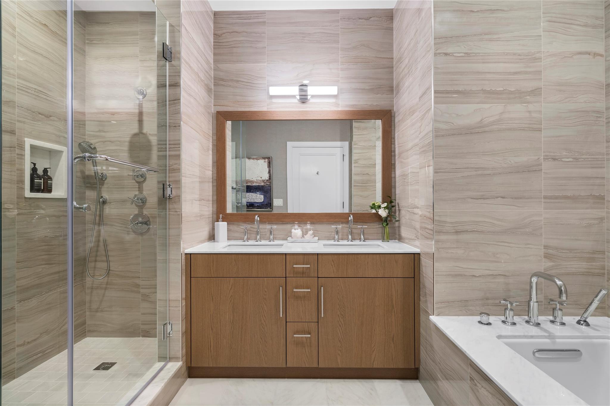 100 Garvies Point Road, Unit 1211 Glen Cove, NY 11542 - Photo 8 of 24 Bathroom with tile walls, vanity, and separate shower and tub