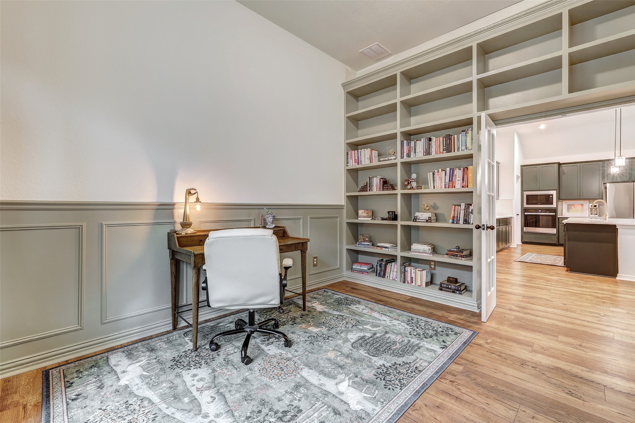 1117 Spring Gulch Lane Georgetown, TX 78628 - Photo 6 of 39 Built-in shelving and classic wainscoting define this adaptable workspace.