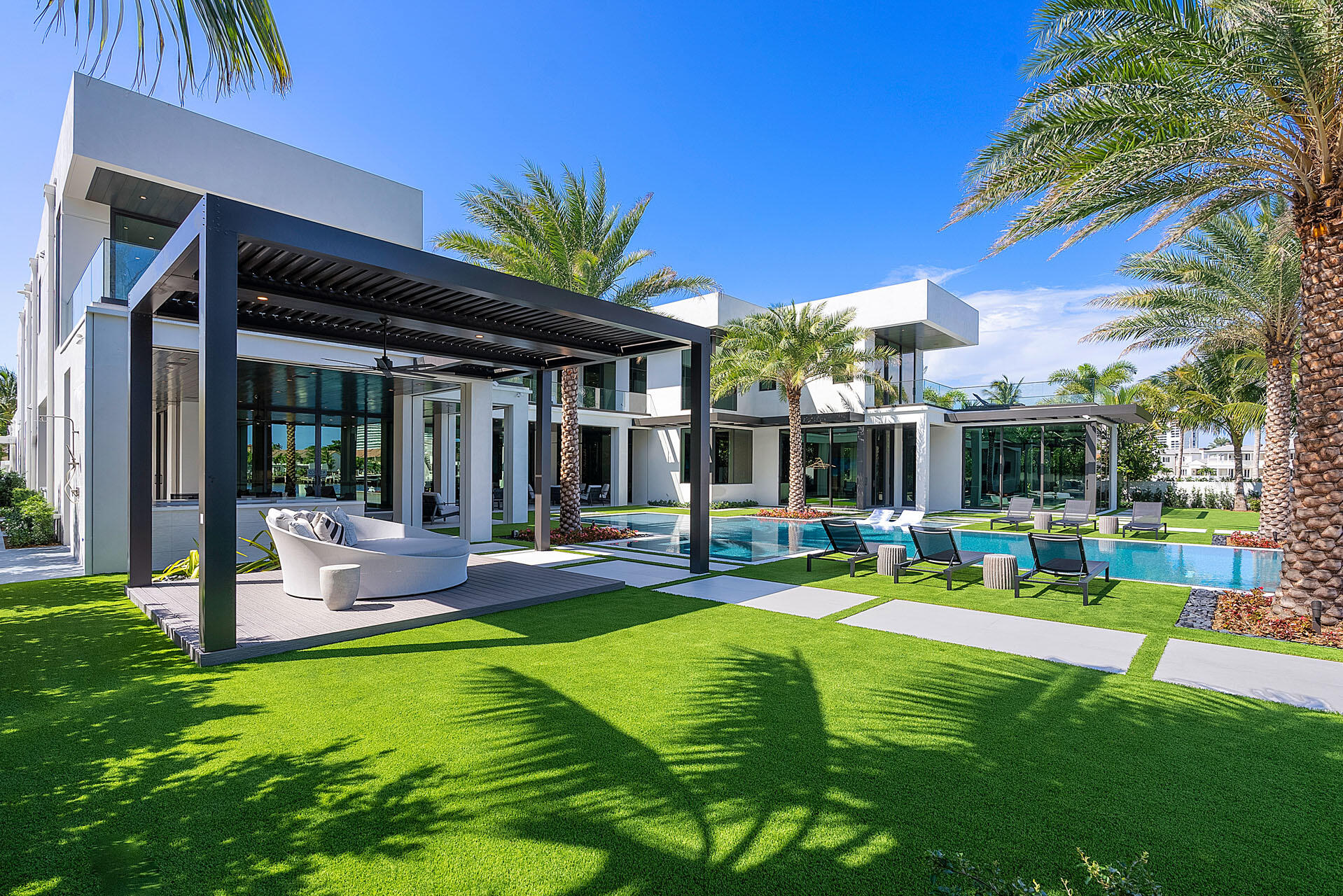 372 East Alexander Palm Road Boca Raton, FL 33432 - Photo 13 of 95 a view of a house with a backyard patio and swimming pool
