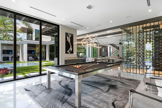 a front view of multi story residential apartment building with yard and green space