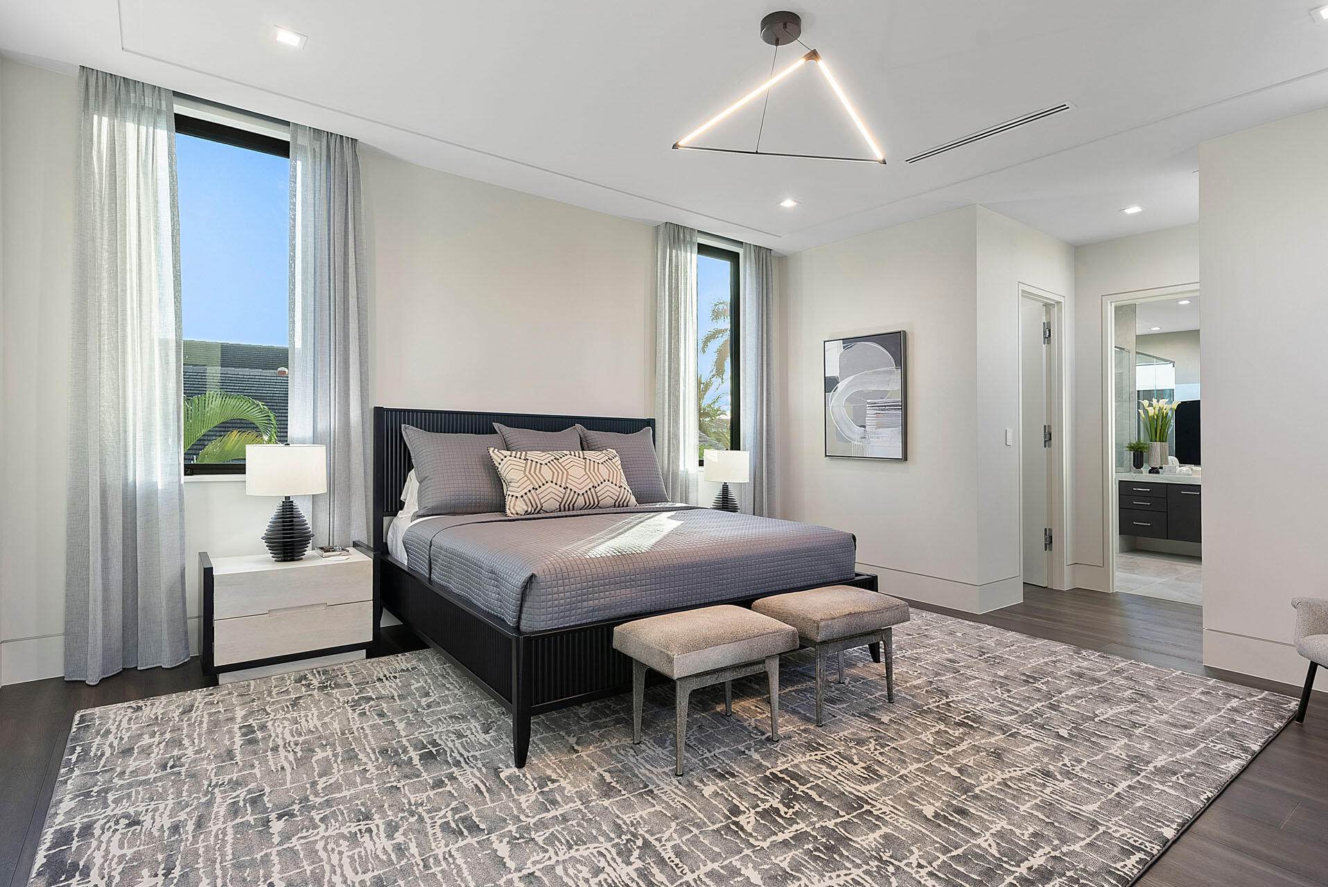 372 East Alexander Palm Road Boca Raton, FL 33432 - Photo 66 of 95 a bedroom with a bed and a chandelier