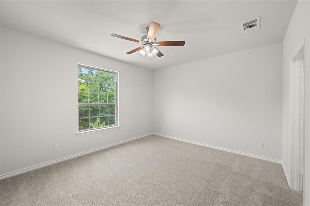 409-411 Saddle Drive Denton, TX 76209 - Photo 15 of 29 an empty room with windows and fan