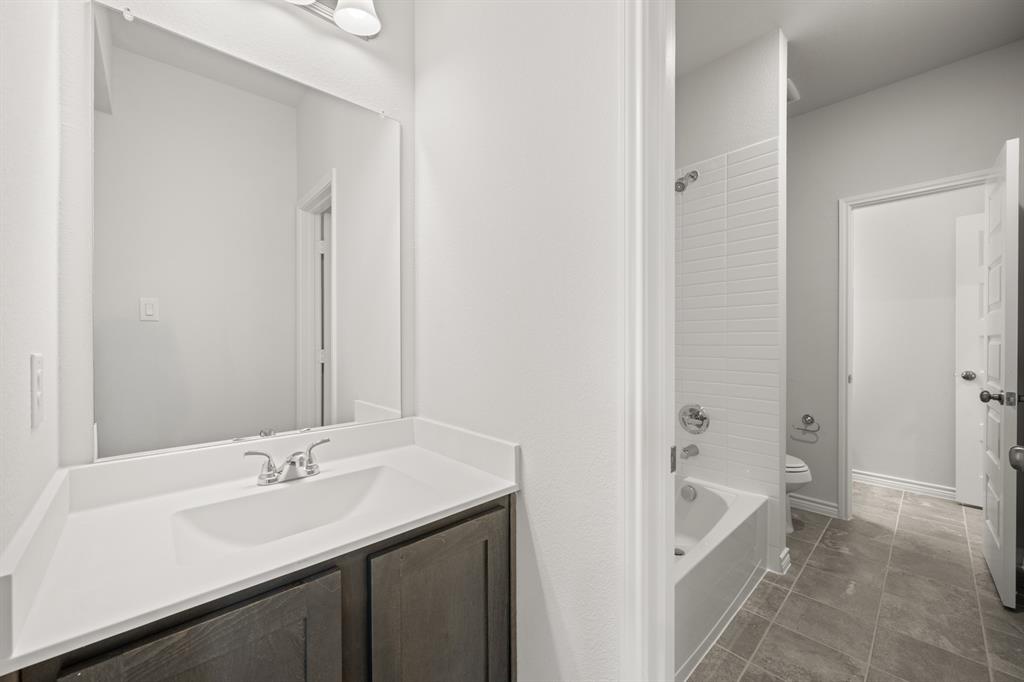 409-411 Saddle Drive Denton, TX 76209 - Photo 22 of 29 a bathroom with a sink and a mirror
