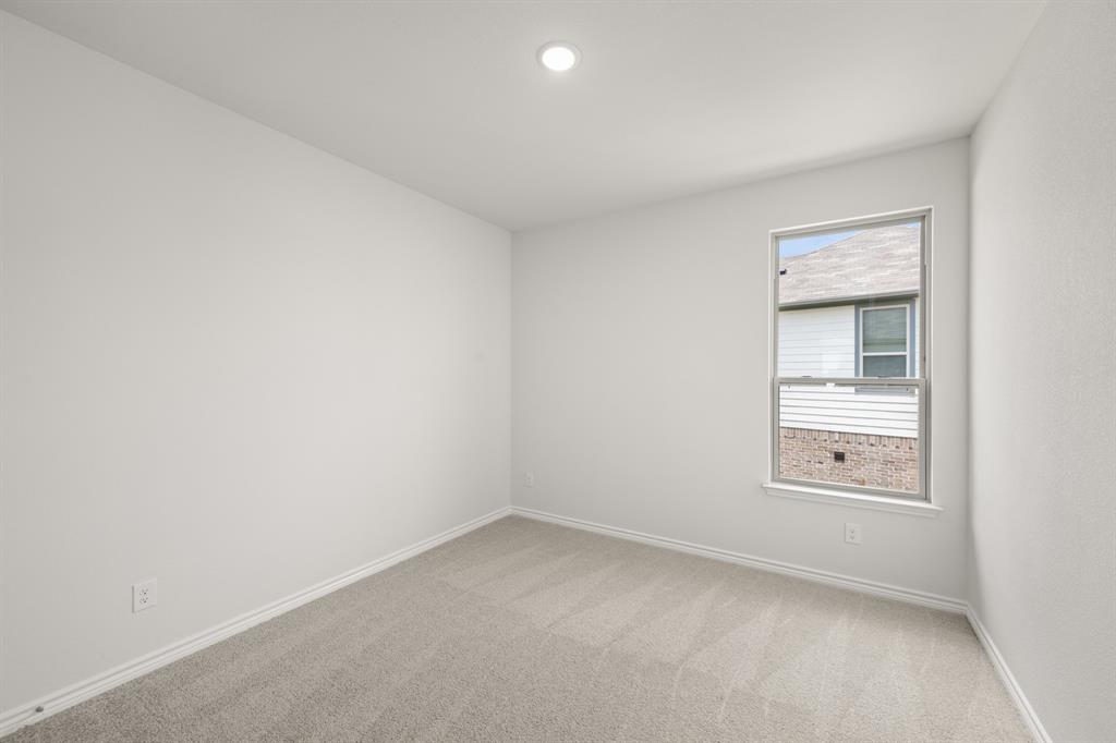 409-411 Saddle Drive Denton, TX 76209 - Photo 25 of 29 an empty room with cabinet and windows