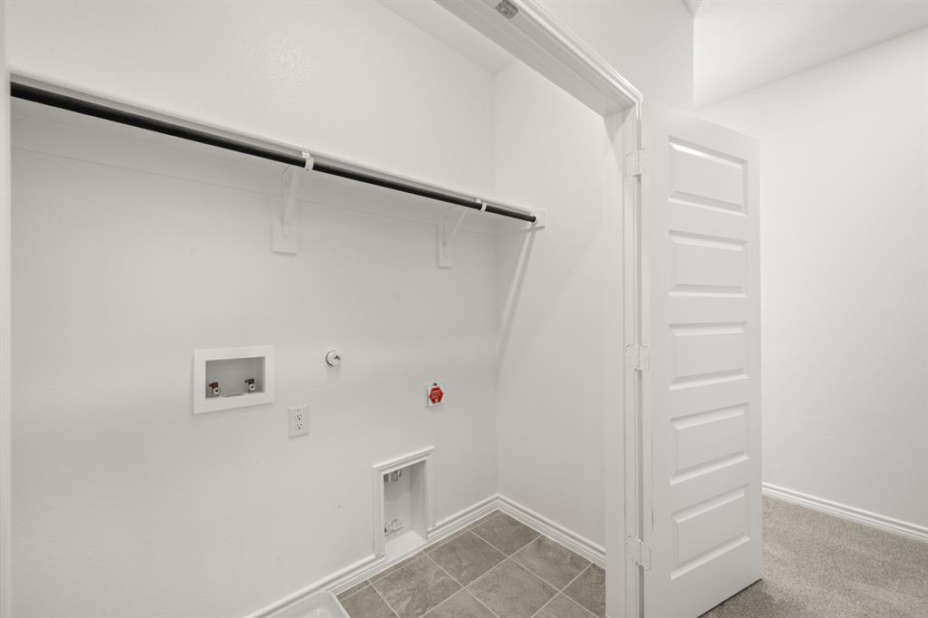 409-411 Saddle Drive Denton, TX 76209 - Photo 26 of 29 a view of walk in closet with empty racks