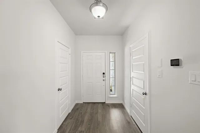 a large kitchen with stainless steel appliances a large counter top a stove a refrigerator cabinets and a center island