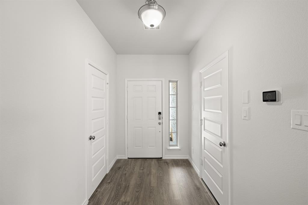 409-411 Saddle Drive Denton, TX 76209 - Photo 5 of 29 a view of a hallway with wooden floor