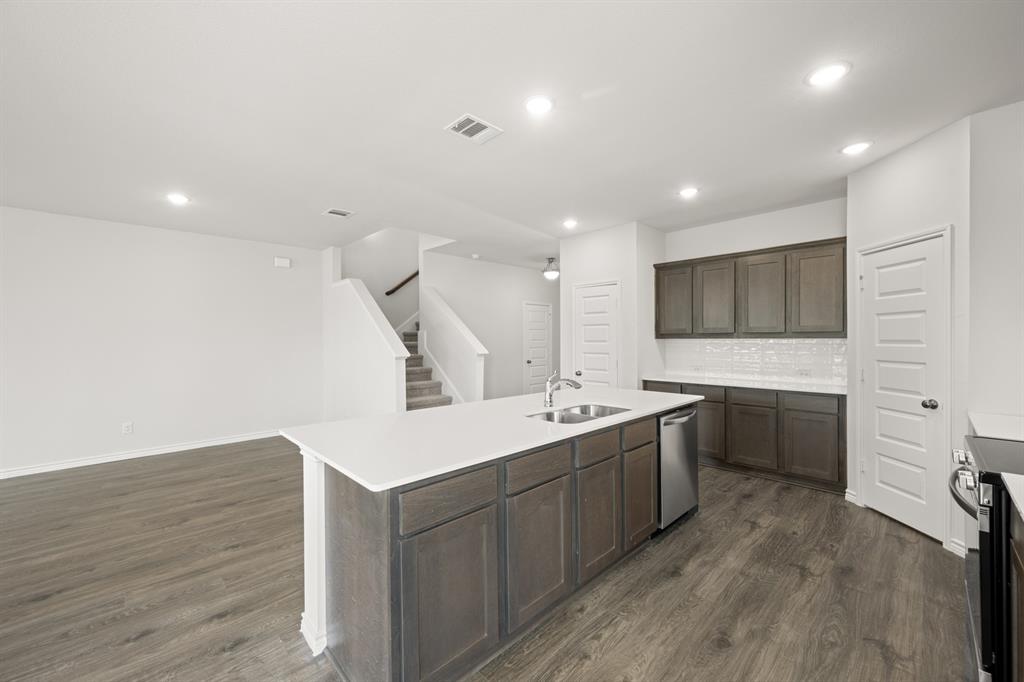 409-411 Saddle Drive Denton, TX 76209 - Photo 9 of 29 a kitchen with a sink stainless steel appliances and cabinets