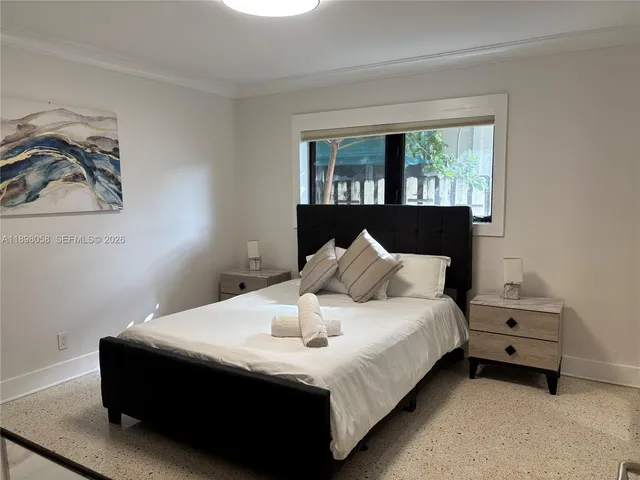 a bedroom with a bed and a television