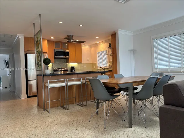 a kitchen with granite countertop a sink and a refrigerator