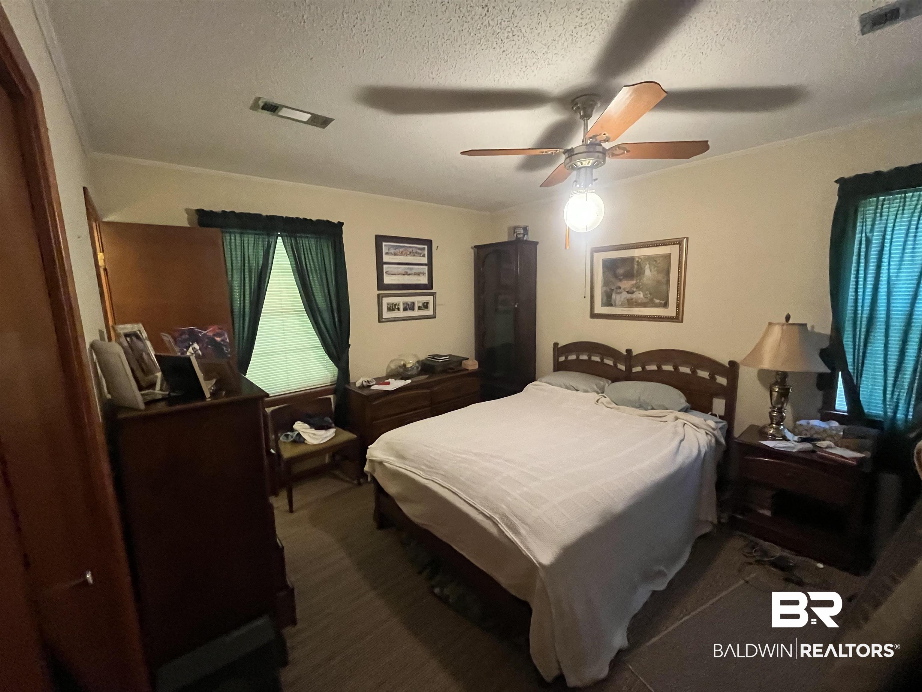 315 Dawkins Road Brewton, AL 36426 - Photo 14 of 19 Bedroom featuring a textured ceiling, visible vents, and carpet