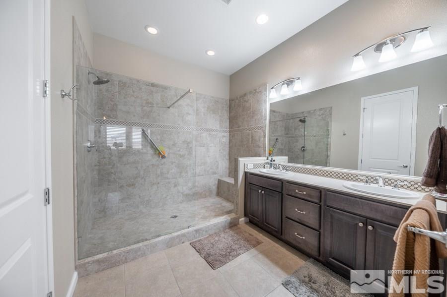 2285 Trakehner Lane, Unit NV Reno, NV 89521 - Photo 13 of 23 a spacious bathroom with a mirror a shower and vanity