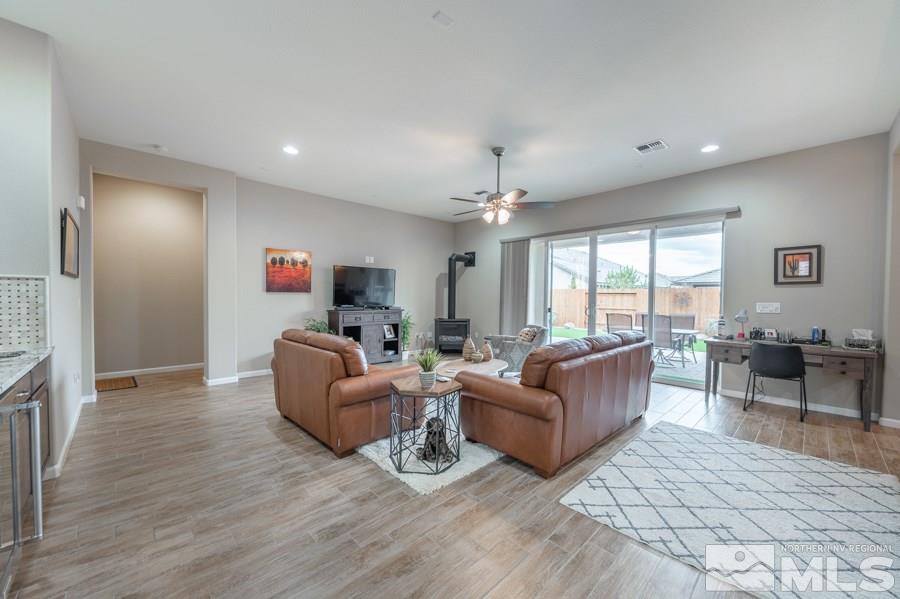 2285 Trakehner Lane, Unit NV Reno, NV 89521 - Photo 3 of 23 a living room with furniture and a wooden floor