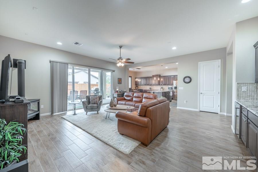 2285 Trakehner Lane, Unit NV Reno, NV 89521 - Photo 4 of 23 a living room with furniture or chandelier and a wooden floor