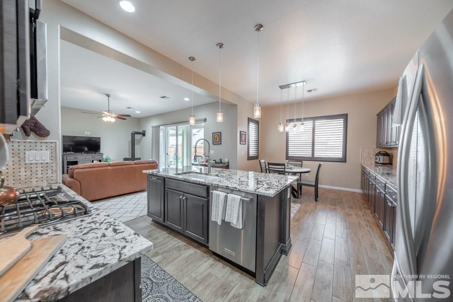 2285 Trakehner Lane, Unit NV Reno, NV 89521 - Photo 9 of 23 a kitchen with stainless steel appliances granite countertop a sink stove and refrigerator