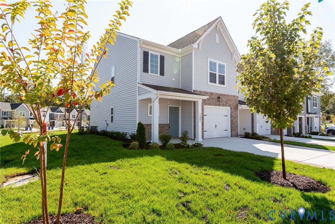 a front view of a house with a yard and trees