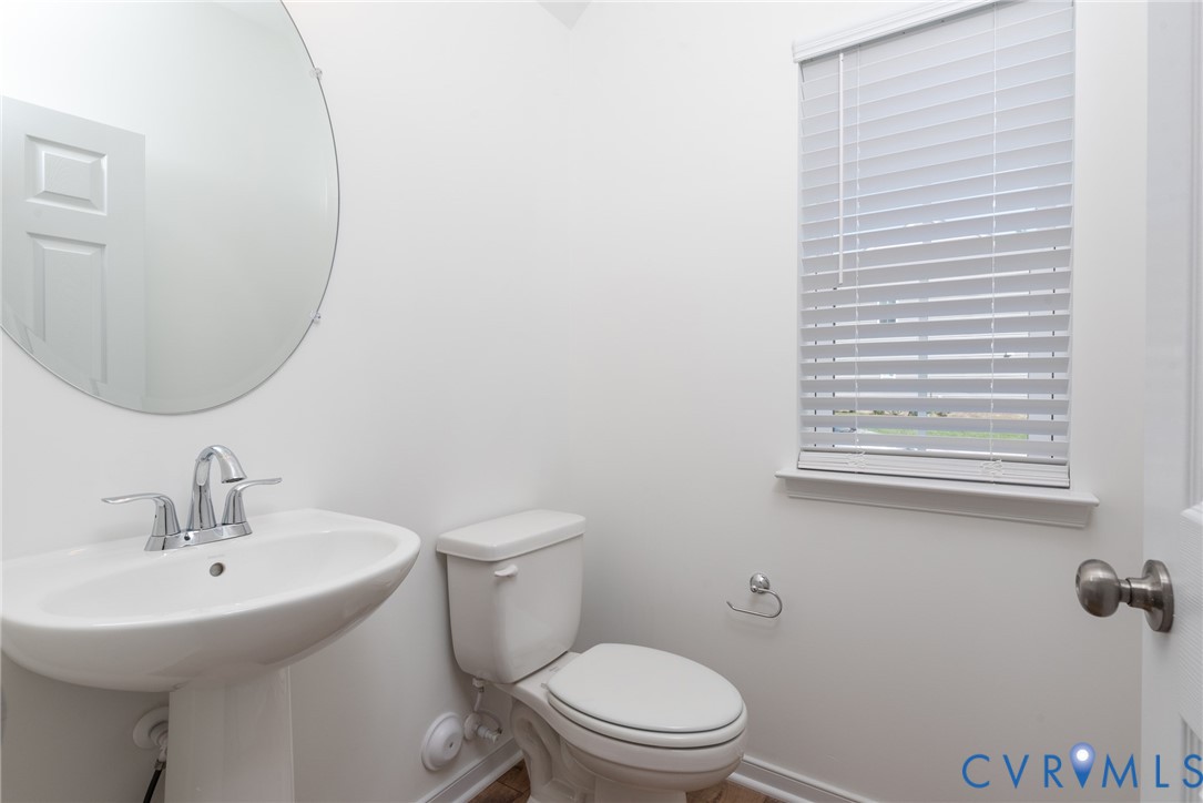 11301 Benton Pointe Way Chester, VA 23831 - Photo 13 of 29 a bathroom with a toilet a sink and mirror