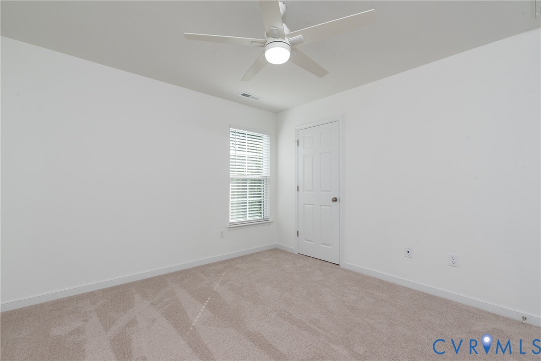 11301 Benton Pointe Way Chester, VA 23831 - Photo 20 of 29 an empty room with a window and ceiling fan