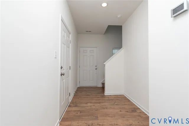 a view of a hallway with wooden floor