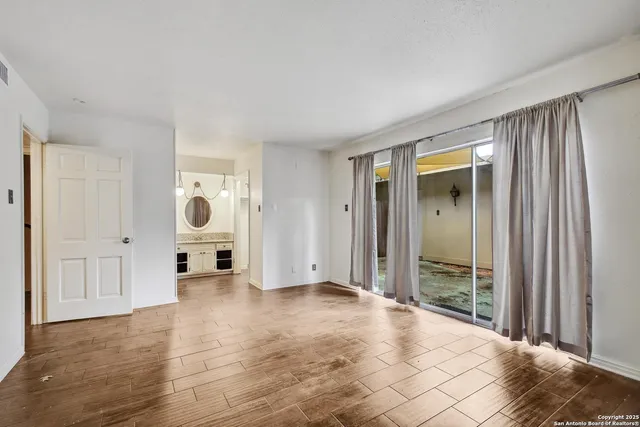 a view of a livingroom with a dinning area wooden floor and staircase