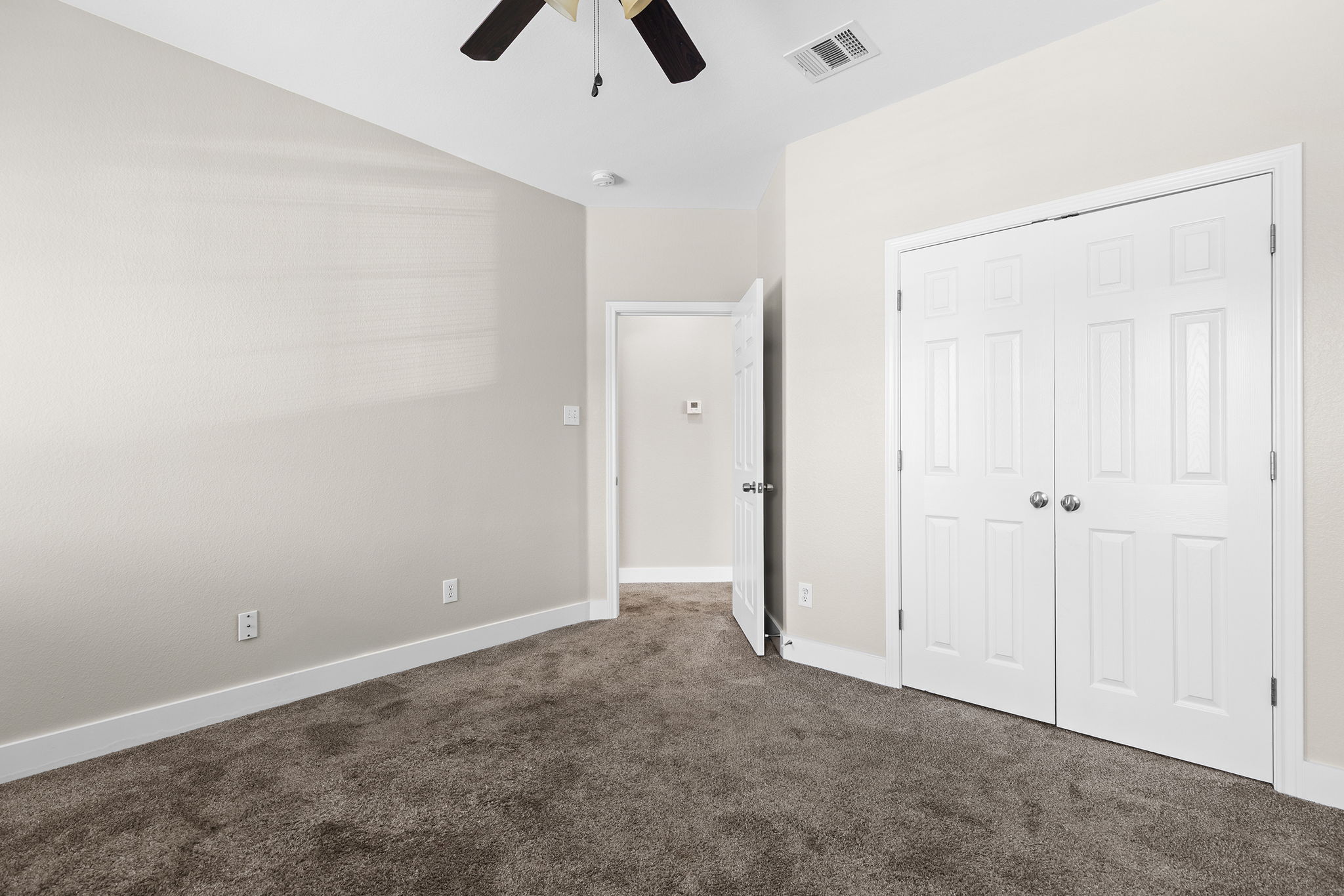 3013 Hawks Swoop Trail Pflugerville, TX 78660 - Photo 35 of 38 Unfurnished bedroom featuring dark colored carpet, a closet, and a ceiling fan