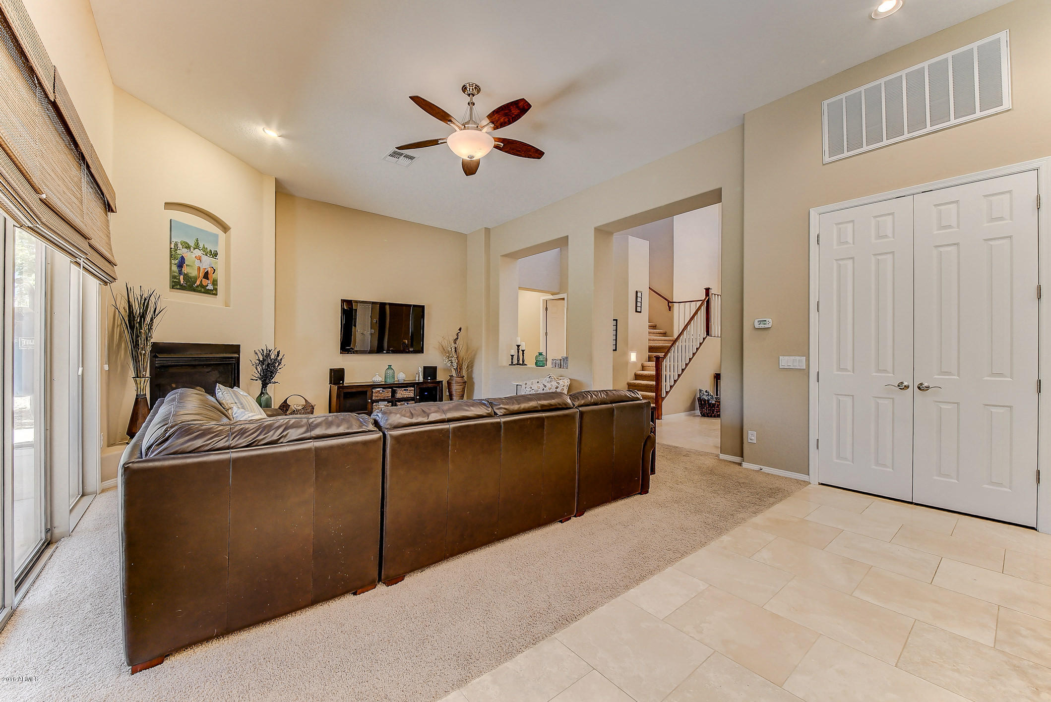 4673 East Ruffian Road Gilbert, AZ 85297 - Photo 18 of 58 a living room with furniture and a flat screen tv