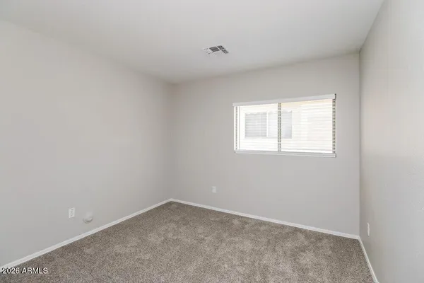 a bathroom with a granite countertop sink mirror vanity and toilet