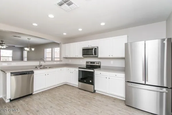 an empty room with windows and fan