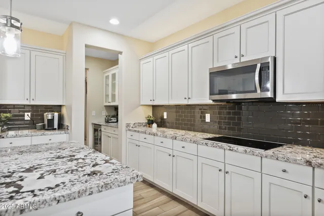 a kitchen with stainless steel appliances granite countertop a sink stove and cabinets