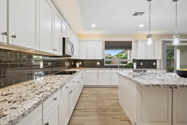 a view of kitchen with sink and window