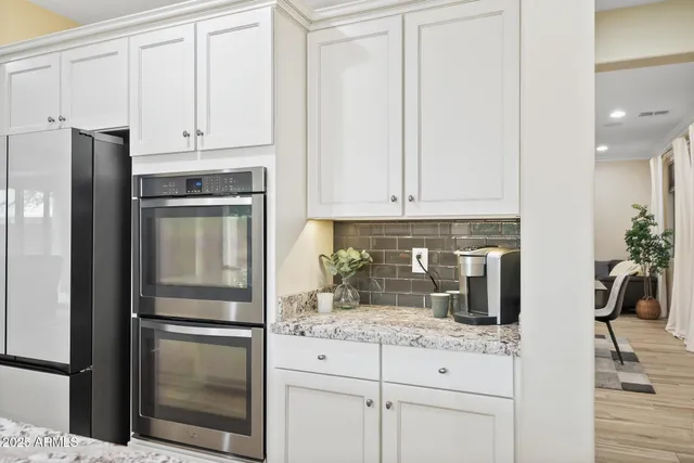 a bathroom with a granite countertop sink and mirror