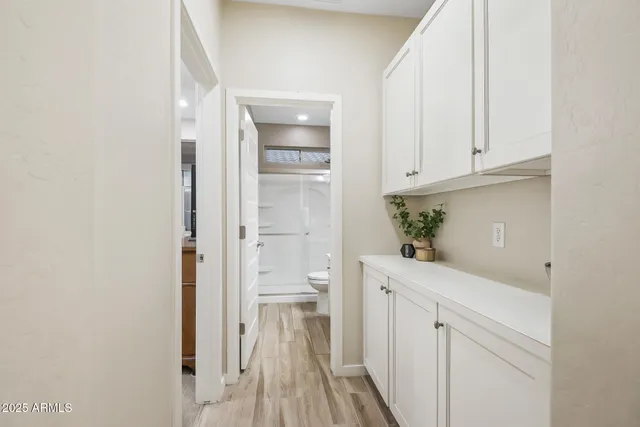 a bedroom with bed and a chandelier