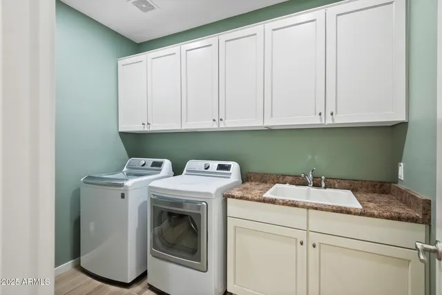 a view of a kitchen with white cabinets