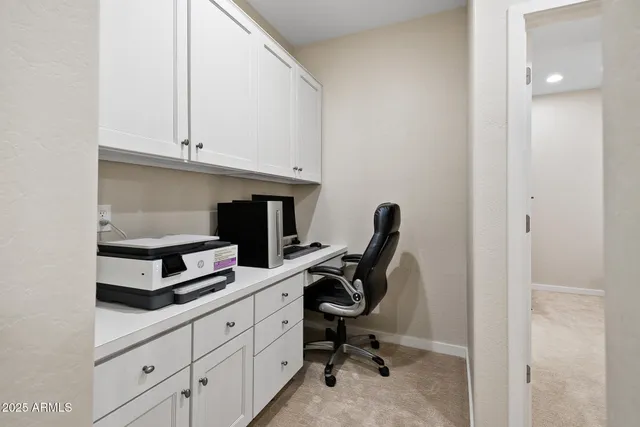 a kitchen with white cabinets and sink