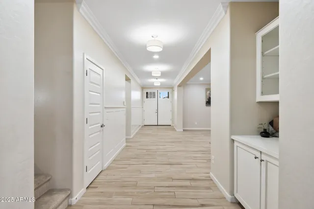 a view of a hallway with wooden floor and a workspace